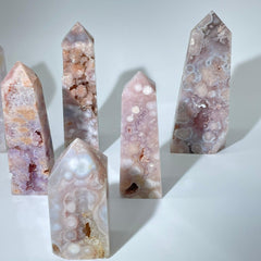 Polished flower agate point showcasing soft blush tones and natural inclusions